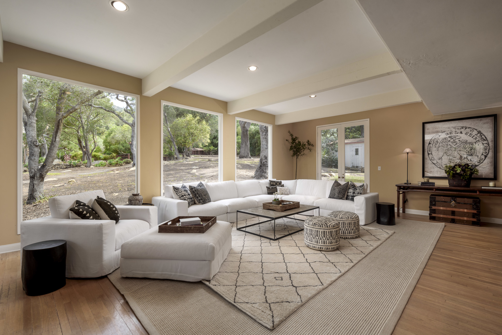 one of the many spacious living areas, framed by romantic oak trees and mountain views.